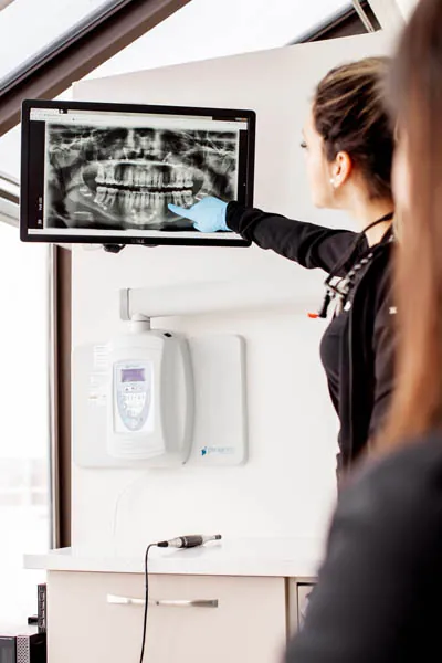 hygienist explaining a patient's dental x-rays to them