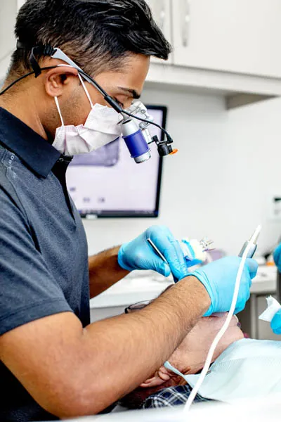 Dr. Gomes providing cosmetic dentistry services for a patient