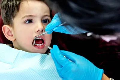 child getting a dental checkup after a frenectomy