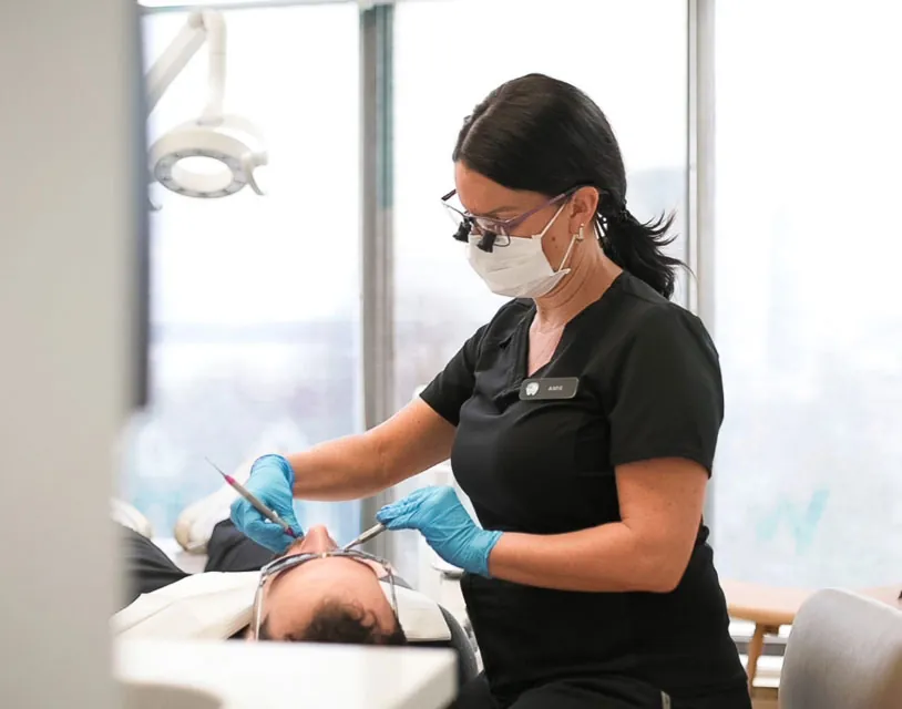 dental hygienist performing an exam on a patient in Barrie, ON