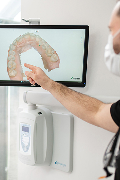 Dr. Gomes providing cosmetic dentistry services for a patient